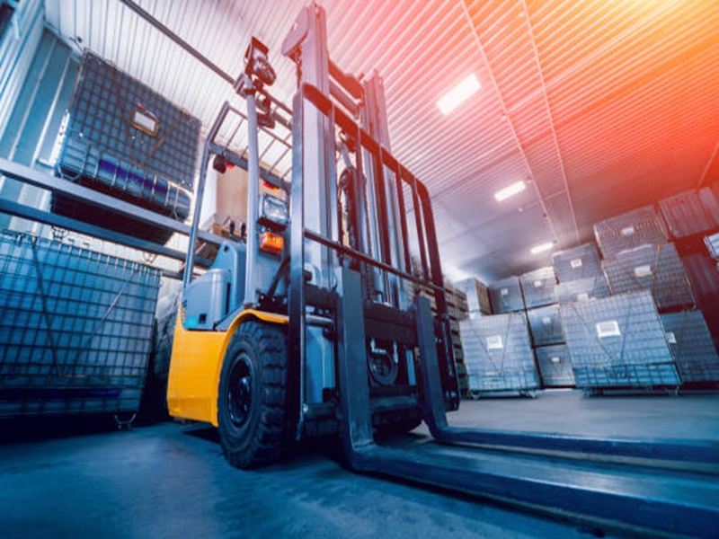 Forklift loader. Pallet stacker truck equipment at warehouse. Background